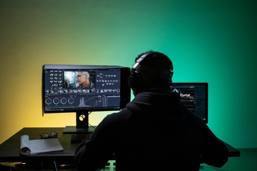 A man doing video editing on a laptop computer